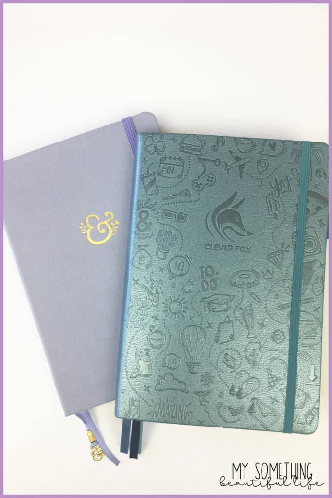 two notebooks; one light purple and one teal