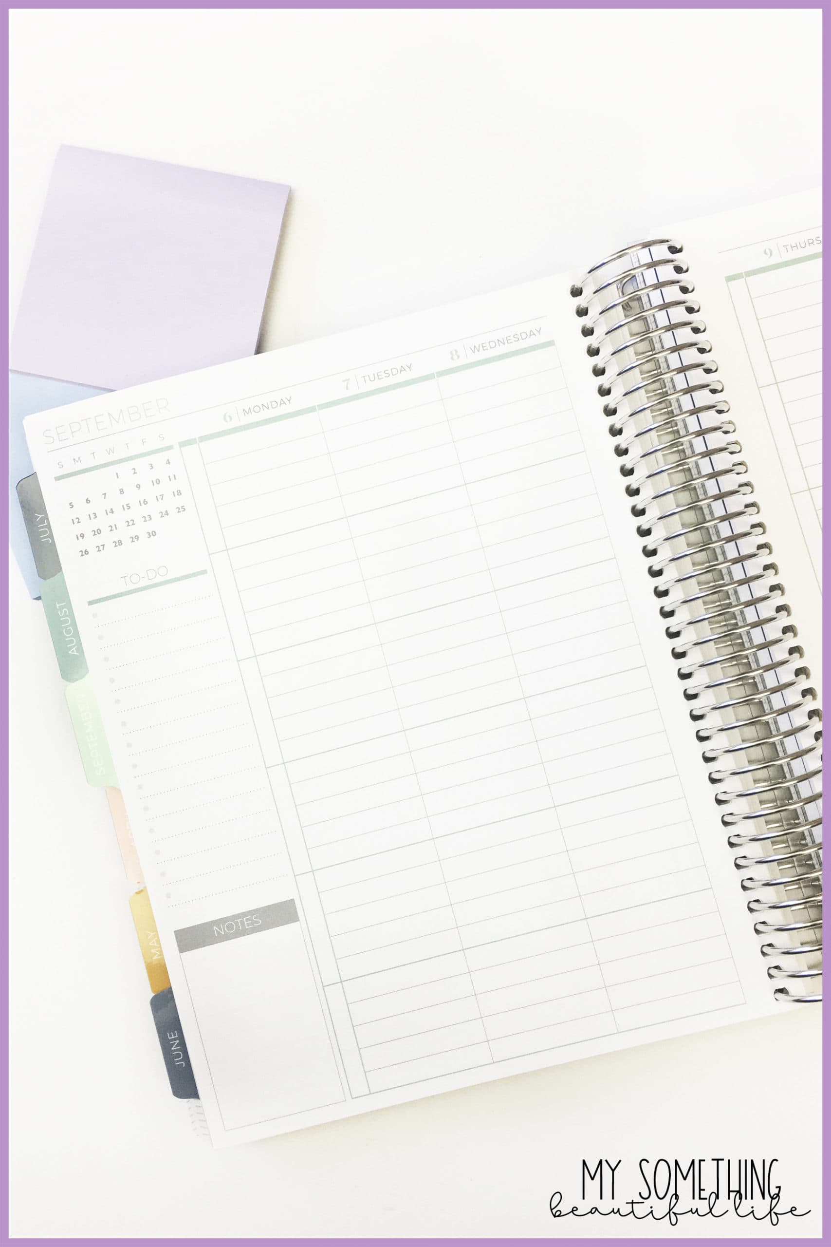 interior of plum paper planner and two sticky note pads